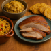 Table set with pork dinner; rice and limes.
